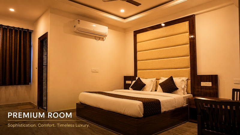 Spacious Premium Room at Hotel The Black Gold with a 50-inch 4K Smart TV and plush bedding.